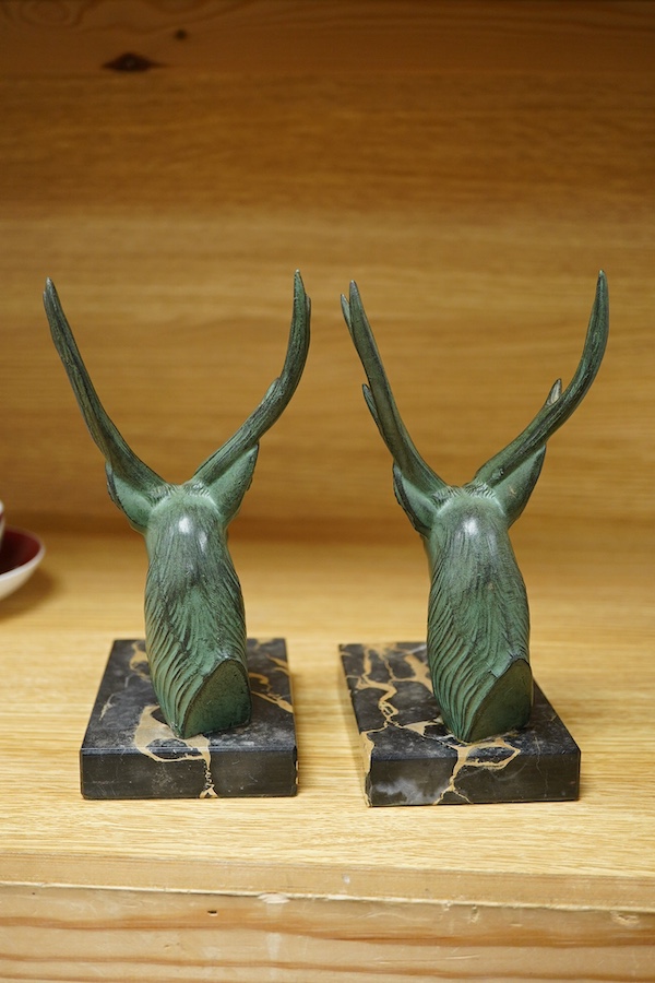 A pair of French bronzed stags head bookends, 19cm high